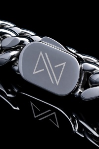 Macro photo of chain clasp with reflection in black glass